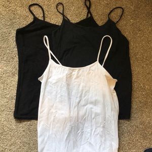 three tank tops, black and white